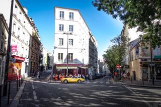 Car parked in front of a typical parisian bar