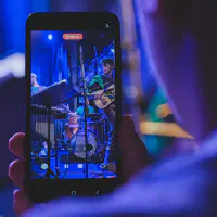A phone recording the concert. We can see Jean-Loup playing Guitar on the screen