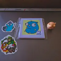 Swag from the Golang room. A sticker, a Puzzle, and a 3d printed figurine. All of a Golang Gopher. 