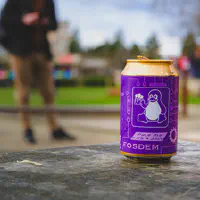 A can of FOSDEM beer brew. Purple with a Tux on it.