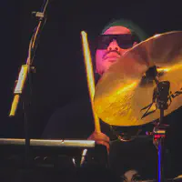 David Frazier playing drums with sun glasses
