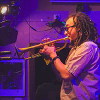 Theo Croker playing trumpet
