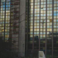 A Palestinian flag hanging of a window on a small sky scraper in from of the ULB Brussel. 