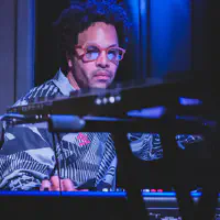 Tony Tixier playing piano and keyboard at the same time